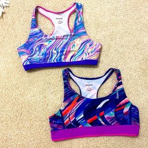 A pair of two girls Reebok sports bras
